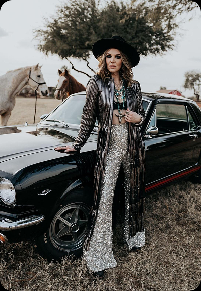 Model posing with a classic car during a style shoot